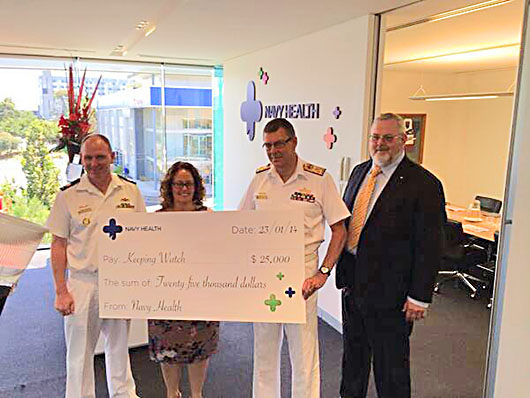 Syd Lemon, Chairman of Navy Health hands over a cheque for $25,000 to Vice Admiral Ray Griggs, Chief of Navy at the Navy Health head office in January 2014.